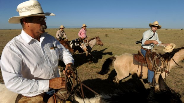 Rancher Duke Phillips, left and Western painter Duke Beardsley, right, ride together for the last round up of cattle for the season. 