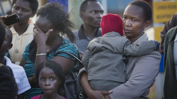 Relatives wait for news of the return of the bodies of those killed in the bus ambush.