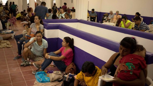 People wait for the arrival of Hurricane Patricia at a shelter in Puerto Vallarta.