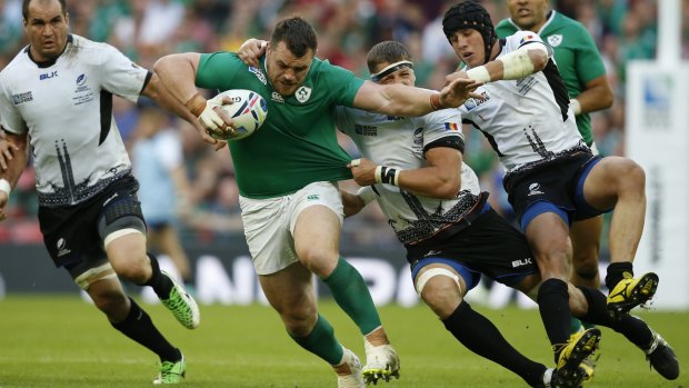 Ireland's Cian Healy is brought to ground by the Romanian defence.