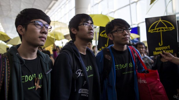 Grounded: Nathan Law, left, Alex Chow and Eason Chung at Hong Kong International Airport, where they were told they could not travel to China.