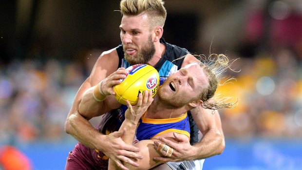 Port Adelaide's Jackson Trengove wraps up Daniel Rich in a tackle.