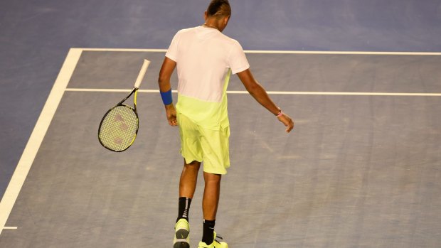 Kyrgios walks past his bouncing racquet.