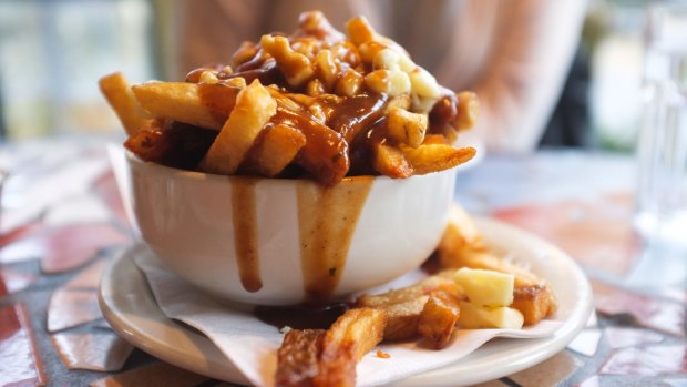 Poutine is a fast food that originated in Quebec; fries topped with curds and gravy.