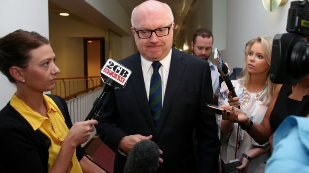 Attorney-General senator George Brandis is questioned by journalists.