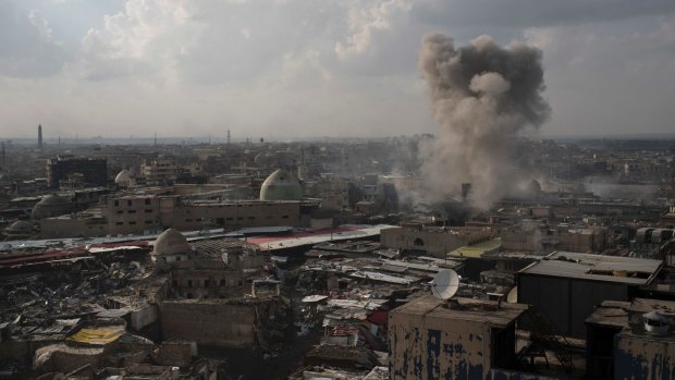 A rocket explodes near the old city during fighting against Islamic State in Mosul,.