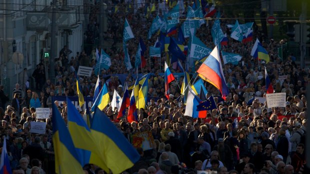 People carry Russian and Ukrainian flags during an anti-war rally in Moscow.