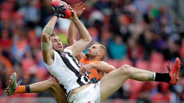 Cloke, wearing the glove on his right hand, takes a mark over Joel Patfull.