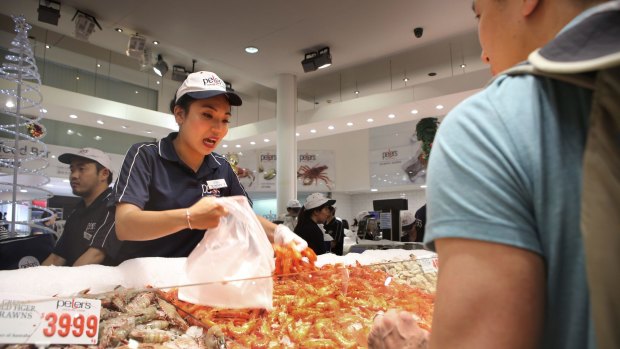 Traders like Kimmy Hung are busy at the counters serving large volumes of customers. Photo: James Alcock /Fairfax Media