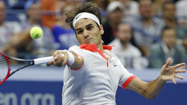 Roger Federer returns during a second-set tiebreak in his fourth-round match against John Isner.