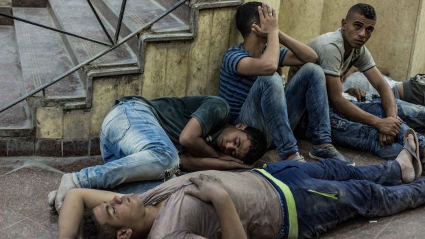 Young Egyptians are detained at a police station after being rescued from the capsized boat.