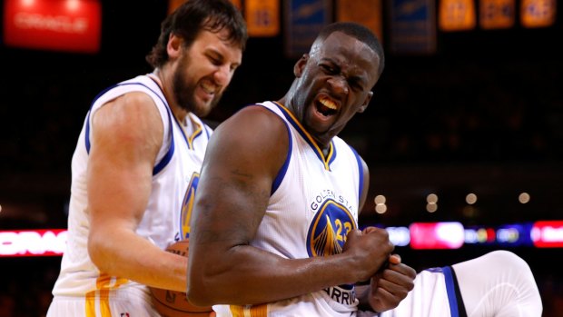 Champions: Draymond Green reacts alongside teammate Andrew Bogut during Golden State's successful NBA playoff campaign.