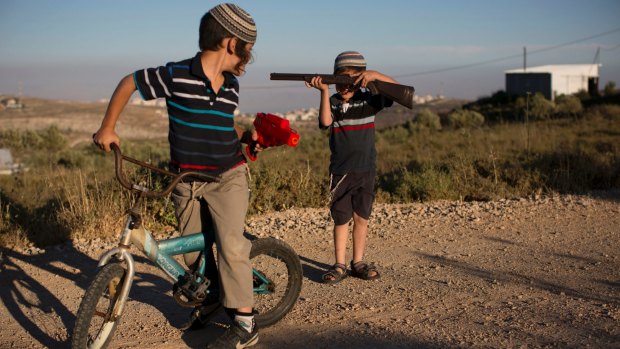 Jewish settler children play with toy guns in the occupied West Bank settlement of Amona earlier this year.