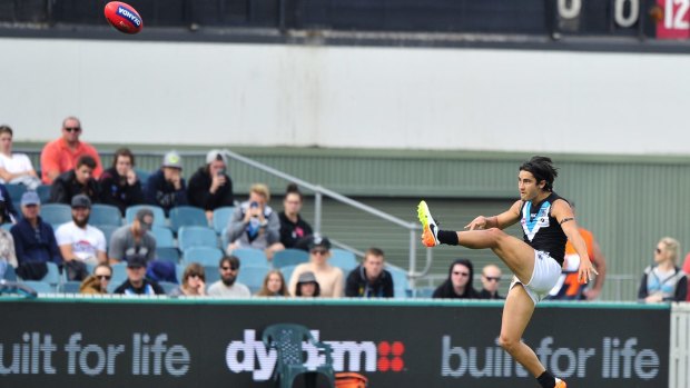 On target: Chad Wingard puts boot in.