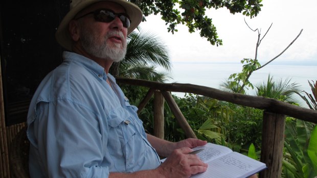 Professor Rick Shine taking field notes in the tropics. 