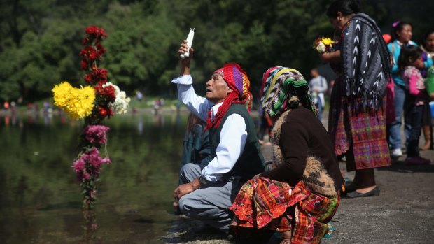 Indigenous people pray at the shore of the Chicabal lagoon during the Prayer of the Rain in Quetzaltenango.