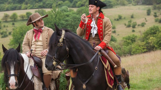 Josh Gad (left) stars as LeFou and Luke Evans as Gaston in <i>Beauty and the Beast</i>.
