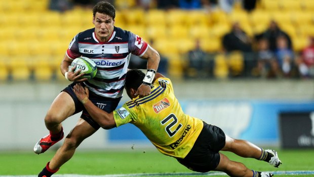 Caught: Rebel Mitch Inman is tackled by Motu Matu'u in the loss to the Hurricanes. 