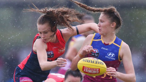 Brisbane's Tahlia Randall clashes with Sarah Lampard of the Demons at Casey Fields.