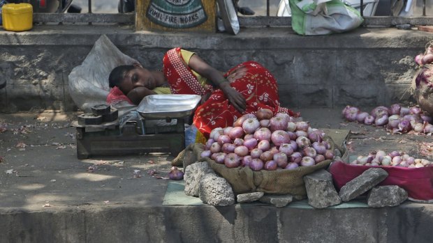 A street vendor rests under the shade of a tree as temperatures climbed above 40 degrees in Hyderabad this week.