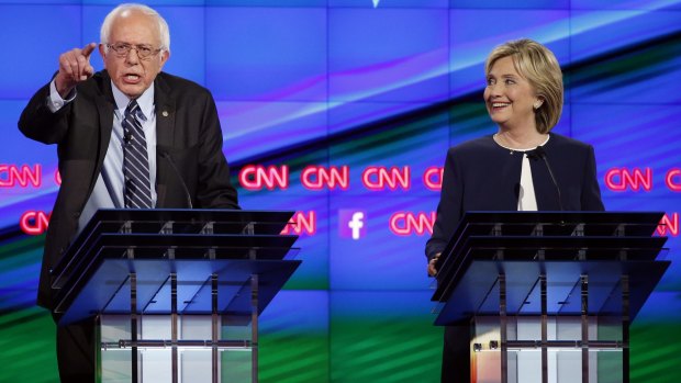 Senator Bernie Sanders, of Vermont makes a point as Hillary Rodham Clinton watches.