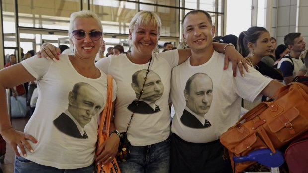 Russian tourists wearing T-shirts with images of Russian President Vladimir Putin pose for a photo in the departure terminal before boarding a flight from Sharm el-Sheikh, Sinai, Egypt, on Friday.