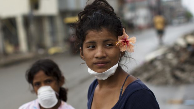 Yesica Zambrano, 15, wearing a flower she found in an earthquake-destroyed home.