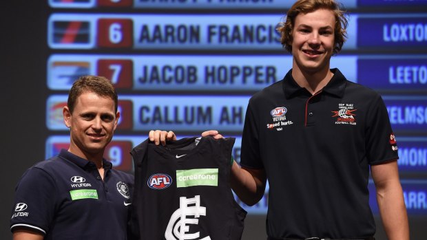 Carlton coach Brendon Bolton presents the club jumper to Harry McKay during the draft.