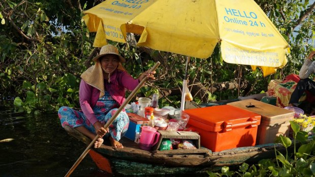 A floating shop passes on Cambodia's Great Lake.
