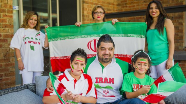Self-confessed football fanatic Ali Parvizi (centre), of Bonython, will cheer on Iran at Friday's AFC Asian Cup quarter-final at Canberra Stadium. He will be joined by his children Navid, 8, (left), and Anita, 7, (right), as well as (back, from left) family members Mehri Roses-Parvizi, Maryam Parvizi and Danielle Parvizi.
