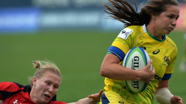 Denied again: Chloe Dalton of Australia runs to score a try during  semi-final against Canada but for the second successive tournament they lost the final to New Zealand.