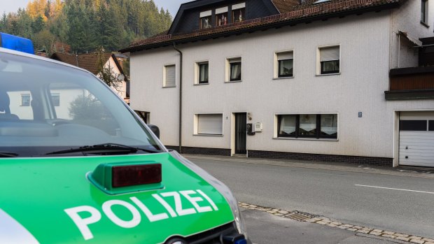 A police car stands in front of a house in Wallenfels, southern Germany where police found bodies of multiple babies. 