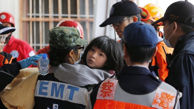 A girl is rescued from the Wei Guan building.