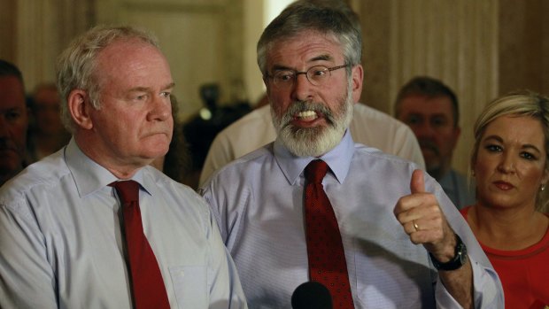 Sinn Fein party leader Gerry Adams, right, and Martin McGuinness speak to the media at Parliament in Belfast, Northern Ireland.