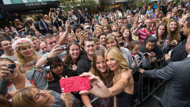 Heidi Klum shares a snap with onlookers in the Bourke Street Mall.