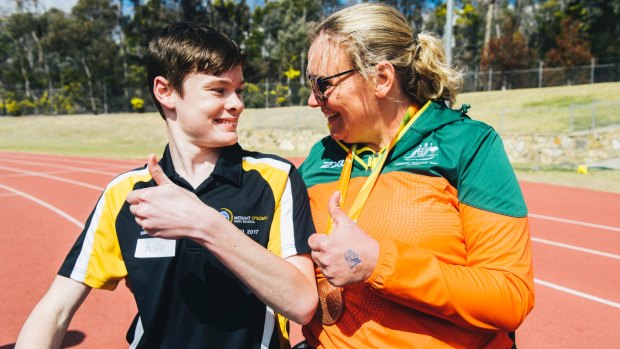 Australian Paralympic athlete Louise Ellery with Stromlo High student Austin Rowlinson at the AIS Athletics Track on Thursday.