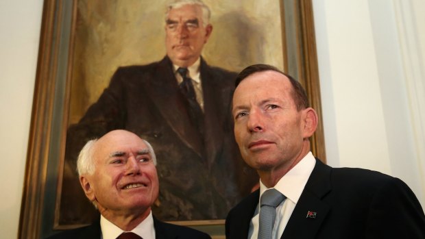 Former prime minister John Howard (left) and Prime Minister Tony Abbott stand before a portrait of their political predecessor Robert Menzies.