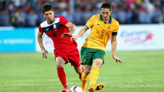 Challenge: Kyrgyzstan's Murzaev Mirlan vies with Mark Milligan for the ball during the 2018 FIFA World Cup qualifier at Dolen Omurzakov Stadium in June.