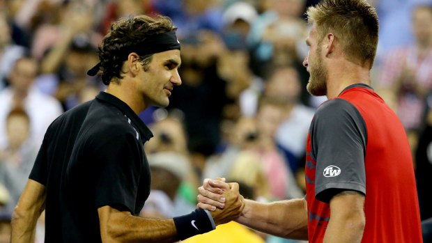 Well done: Roger Federer and Sam Groth at the net after match point.