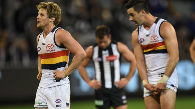 Honours even: Crows Rory Sloane (left) and Taylor Walker look after claiming two points in drawn result against the Pies.