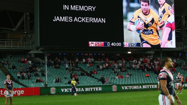 Dragons and Roosters players observe a minute silence to remember rugby league player James Ackerman.