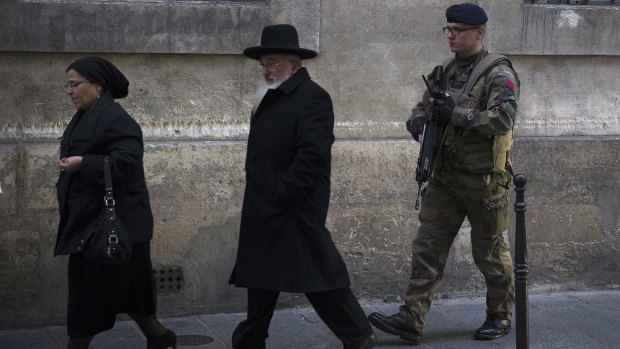 Troop support: A French soldier patrols near a Jewish school in Paris.
