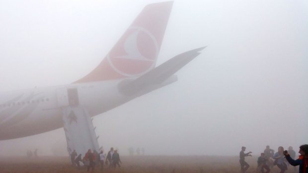 A passenger slides down the escape slide from the Turkish Airlines plane.