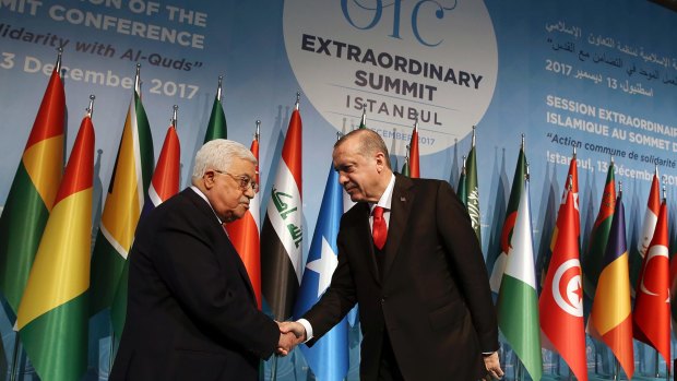 Turkish President Recep Tayyip Erdogan, right, shakes hands with Palestinian President Mahmoud Abbas.