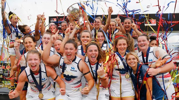 Crows players celebrate their AFL Women's grand final success.