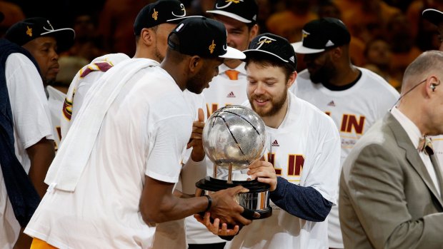 James Jones and Matthew Dellavedova of the Cleveland Cavaliers hold the trophy after defeating the Atlanta Hawks during Game Four of the Eastern Conference Finals of the 2015 NBA Playoffs.