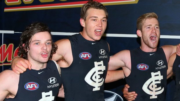 Rare feeling: Dylan Buckley, Patrick Cripps and Nick Graham singing after the round 12 win. 