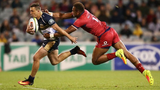 Thomas Banks of the Brumbies is tackled by Chris Kuridrani of the Reds.