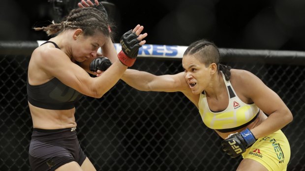 Amanda Nunes lands a punch on Miesha Tate on her way to the women's bantamweight belt at UFC 200.