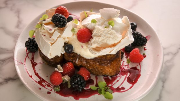 Fried brioche is bejewelled with fresh berries and vanilla meringue.